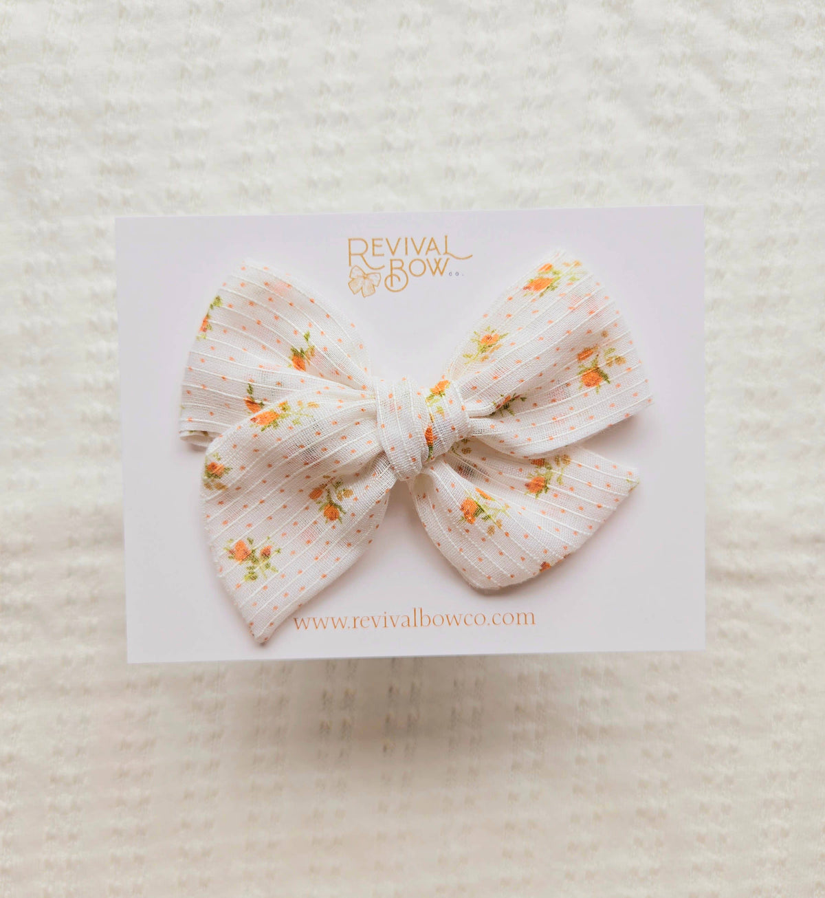 Large Handtied Bow on Clip • Orange Floral Dot