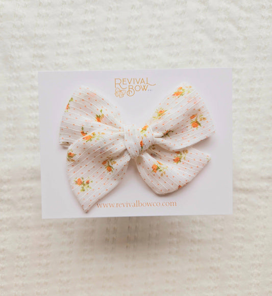 Large Handtied Bow on Clip • Orange Floral Dot